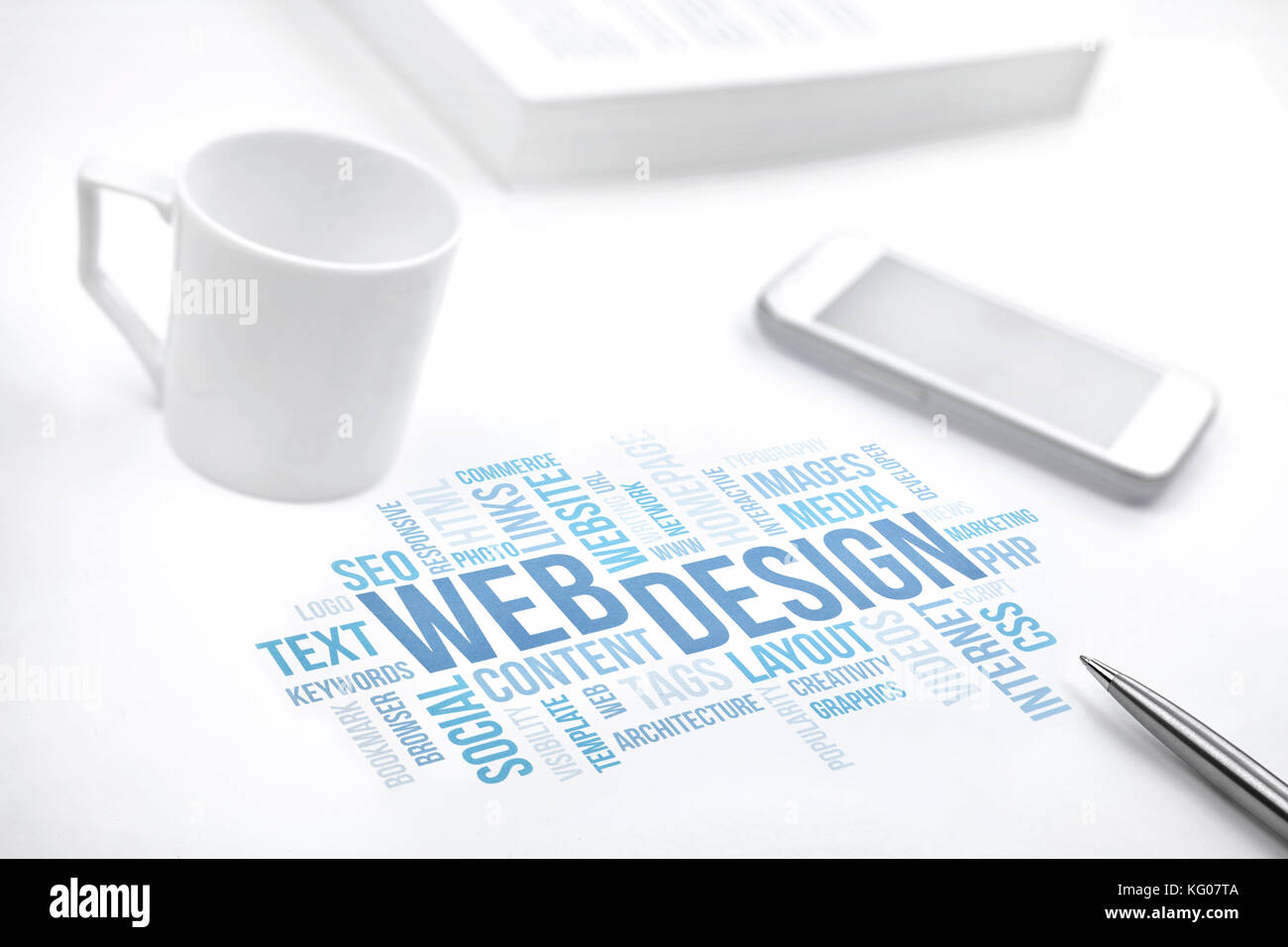 Web Design business concept word cloud print document, smartphone, book, pen and coffee cup. Blue toned. Stock Photo