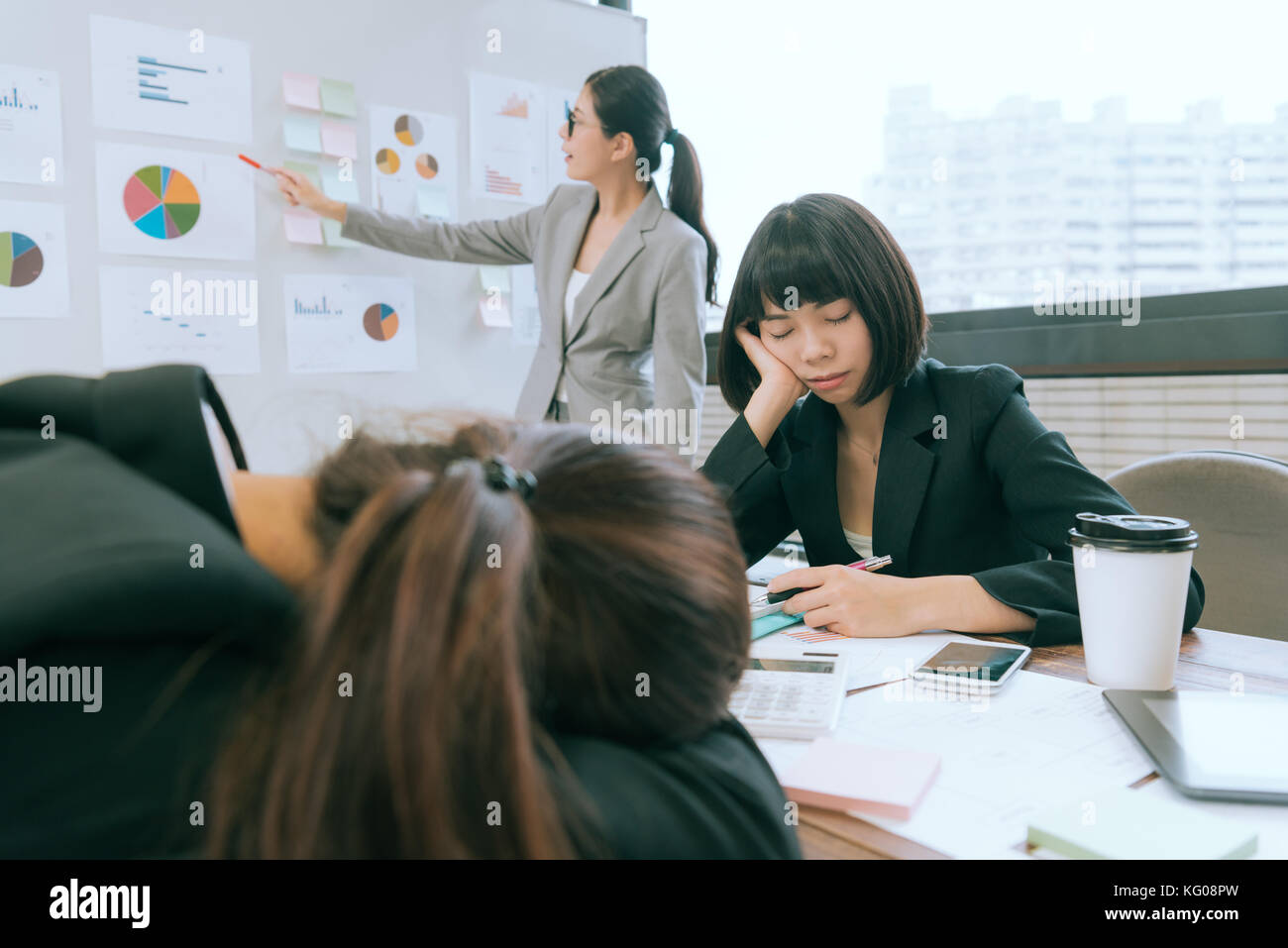 beautiful professional business manager woman using whiteboard showing document report but her colleague feeling boring and sleeping during meeting. s Stock Photo