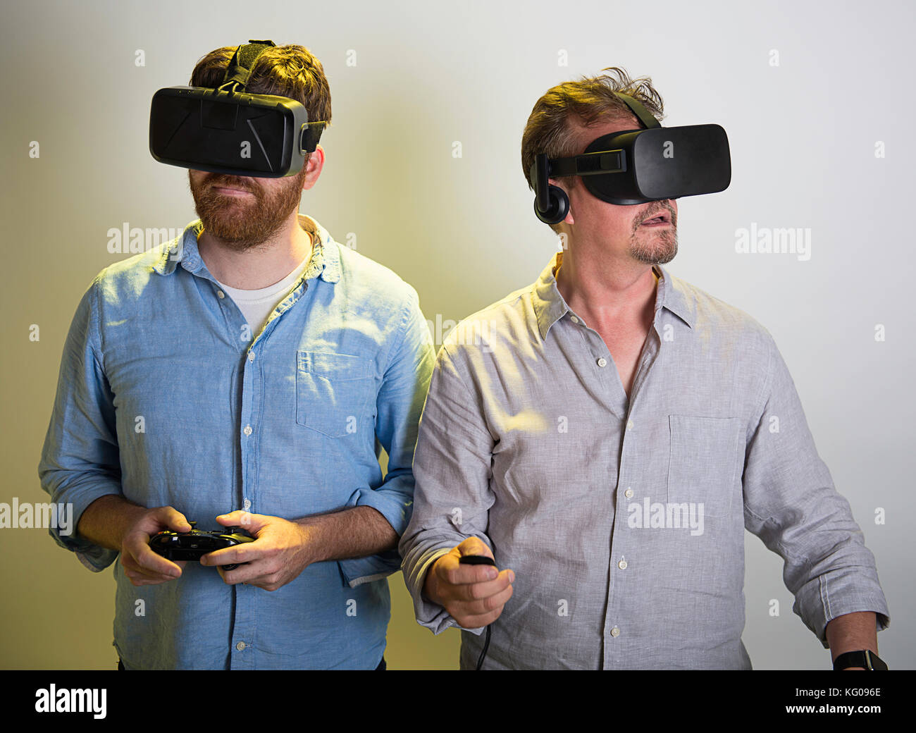 Two men using the Oculus Rift VR headsets, version 2 and 3. Stock Photo