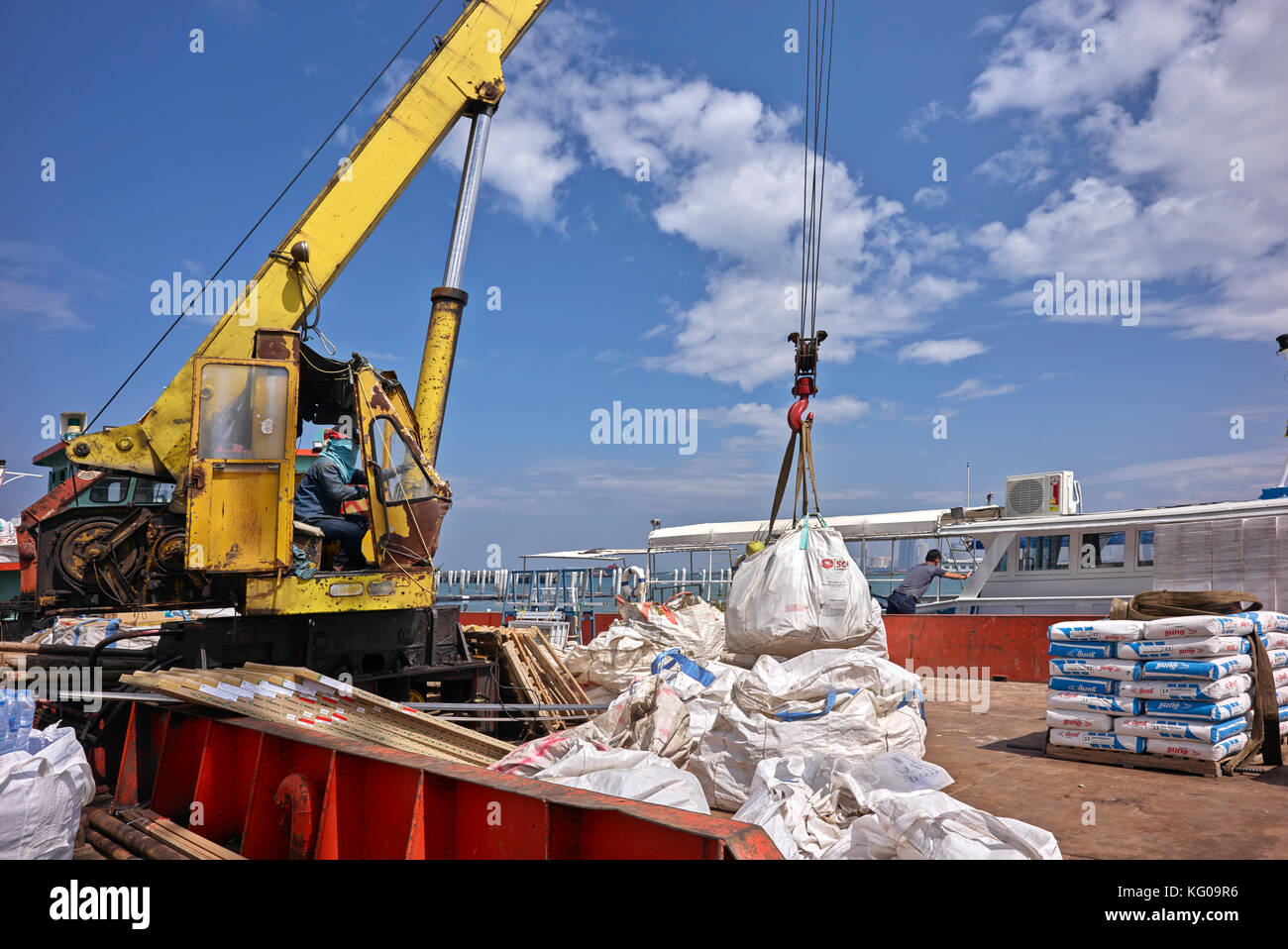Crane loading and unloading boat. Dockworkers at Pattaya commercial ...