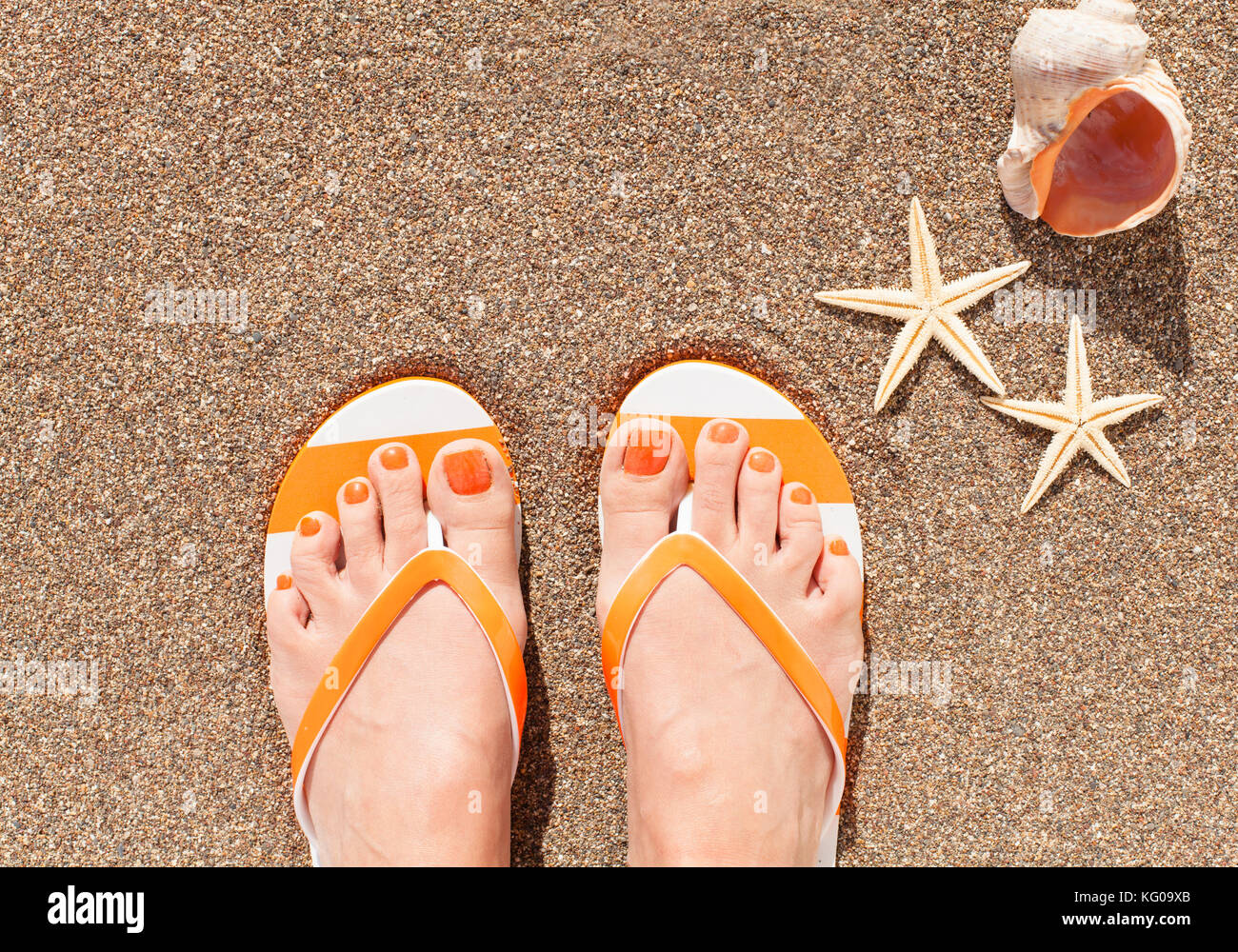 Woman feet wearing flip flops on a beach Stock Photo - Alamy