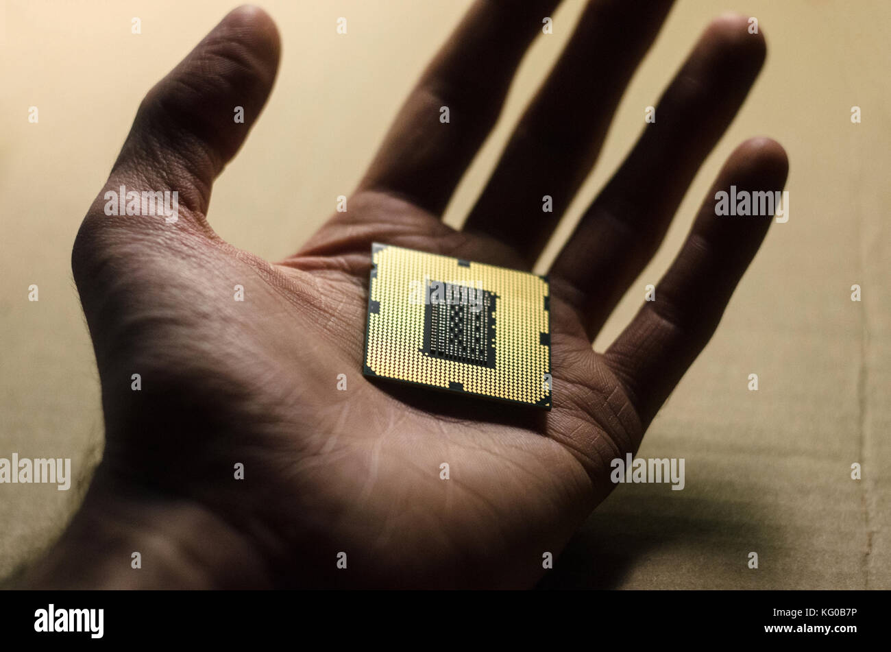 Gold i7 processor in hand Stock Photo