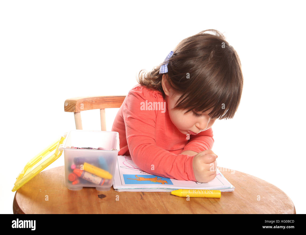 toddler girl colouring with crayons Stock Photo