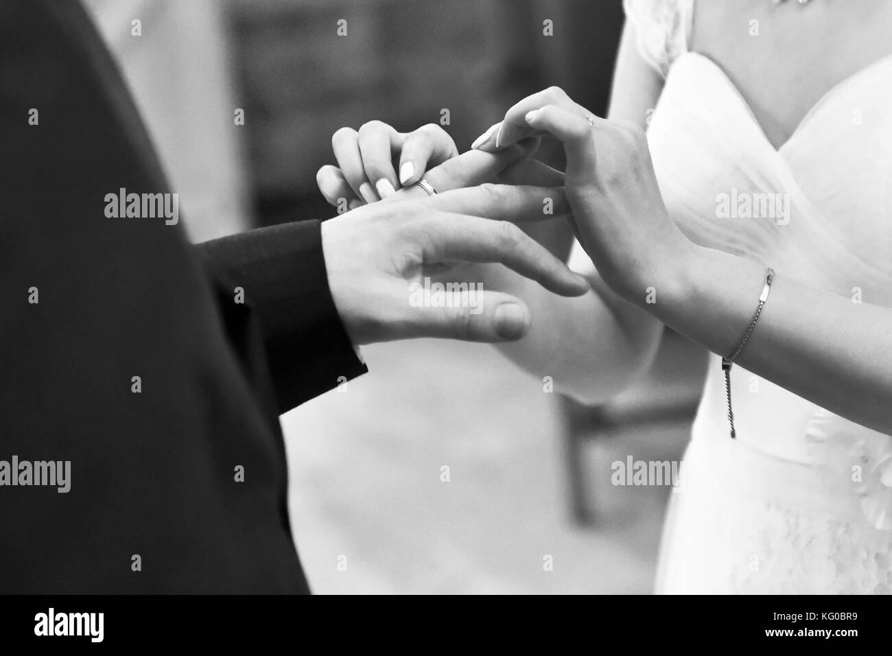 Couple exchange wedding rings on their wedding day Stock Photo