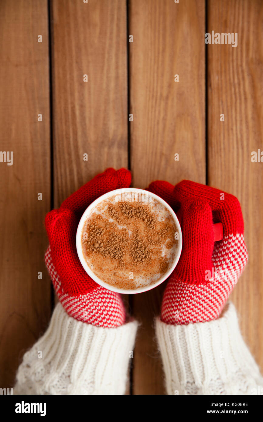 Hands in gloves holding hot cup of coffee Stock Photo - Alamy