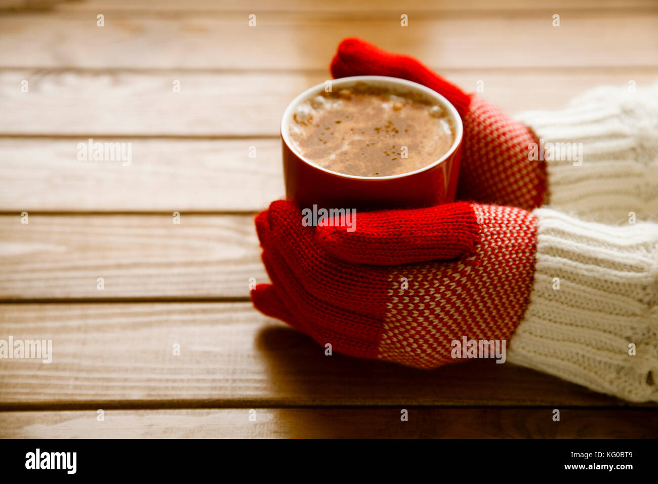 Hands in gloves holding hot cup of coffee Stock Photo - Alamy