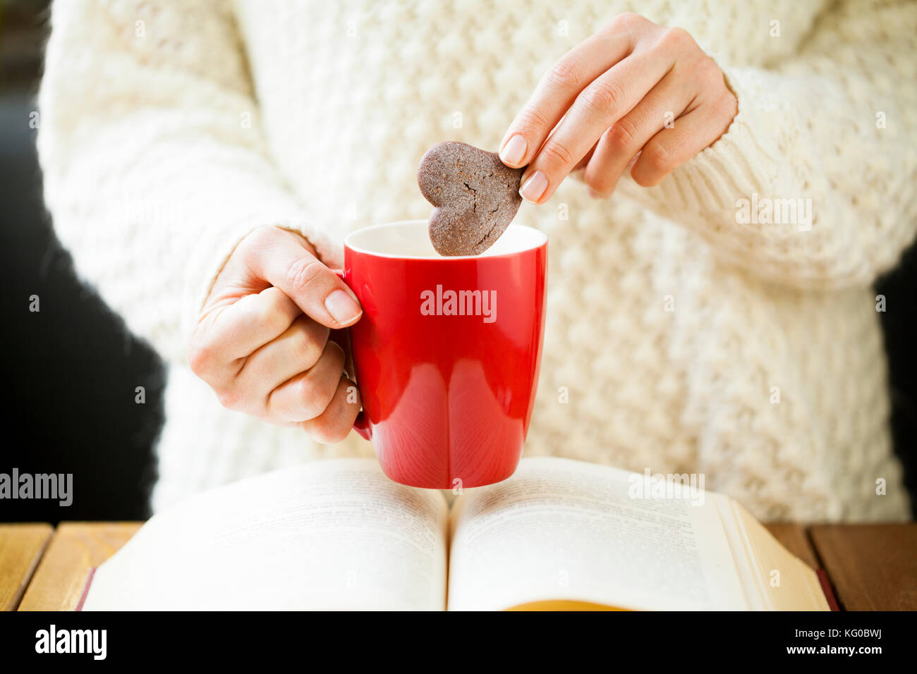 Woman Hand Dipping Cookie in Tea Stock Photo