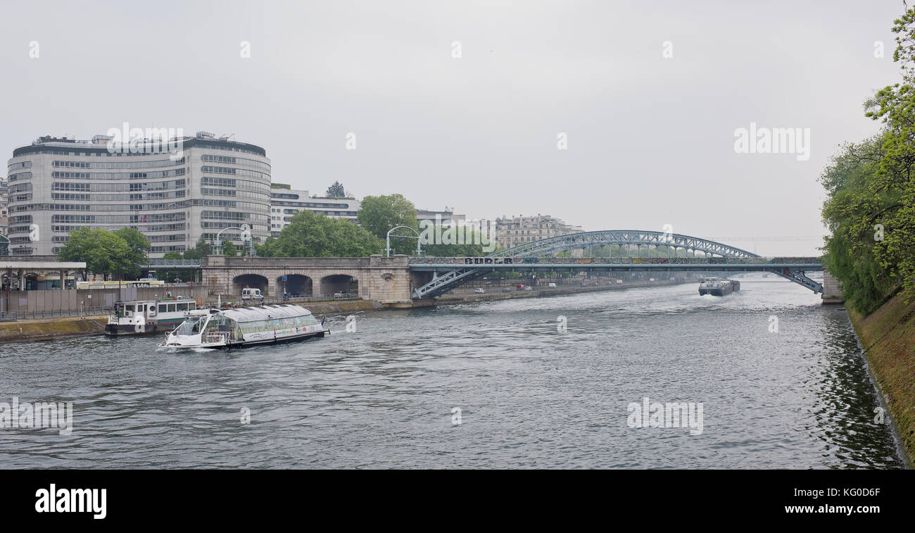 Paris; France-May 05; 2017: View at railway bridge Rouelle crossing Swan Island.On the river ships sail Stock Photo