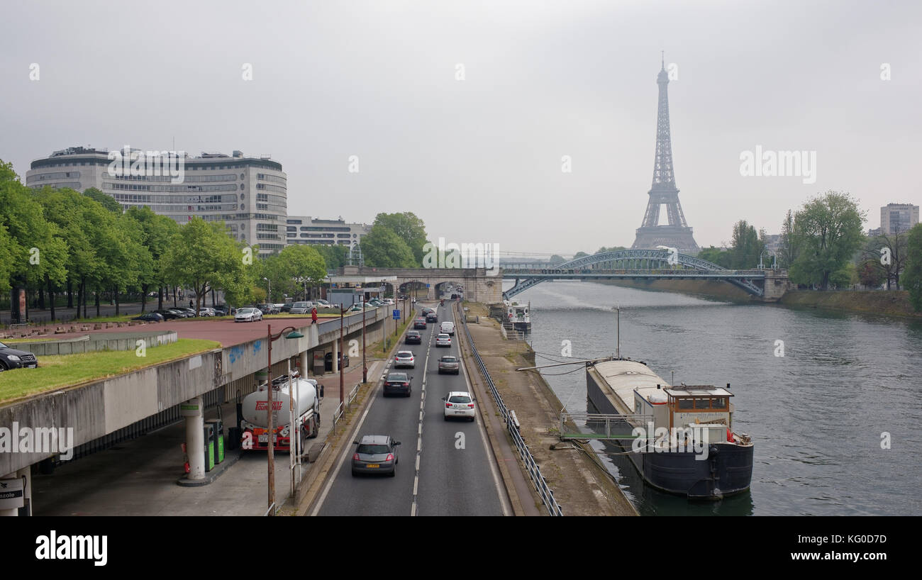 Paris; France-May 05; 2017: View at Eifel tower and railway bridge Rouelle crossing Swan Island.On the road is moving vehicles Stock Photo