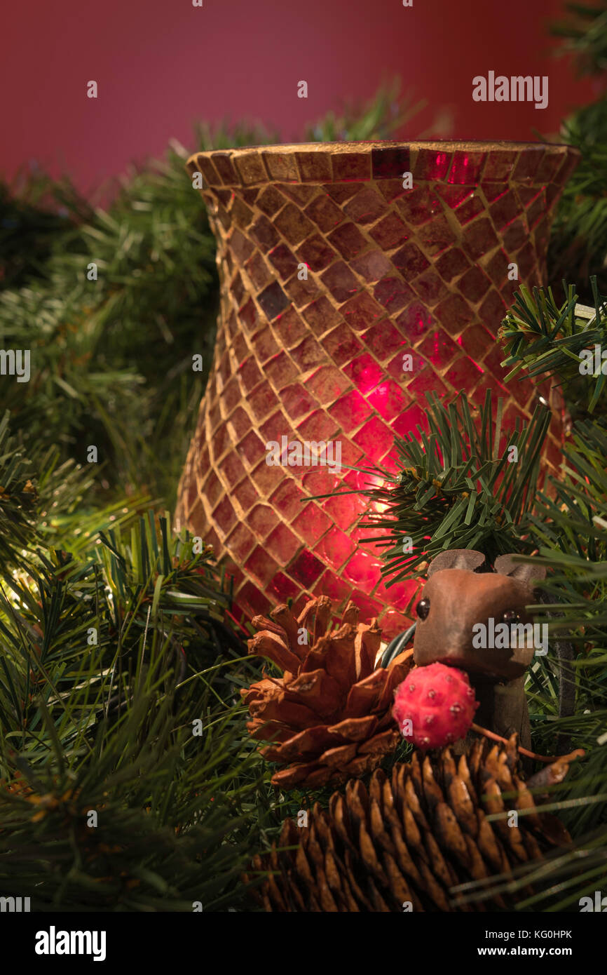 Christmas greenery display with red candle holder, pine cones and little wooden mouse Stock Photo