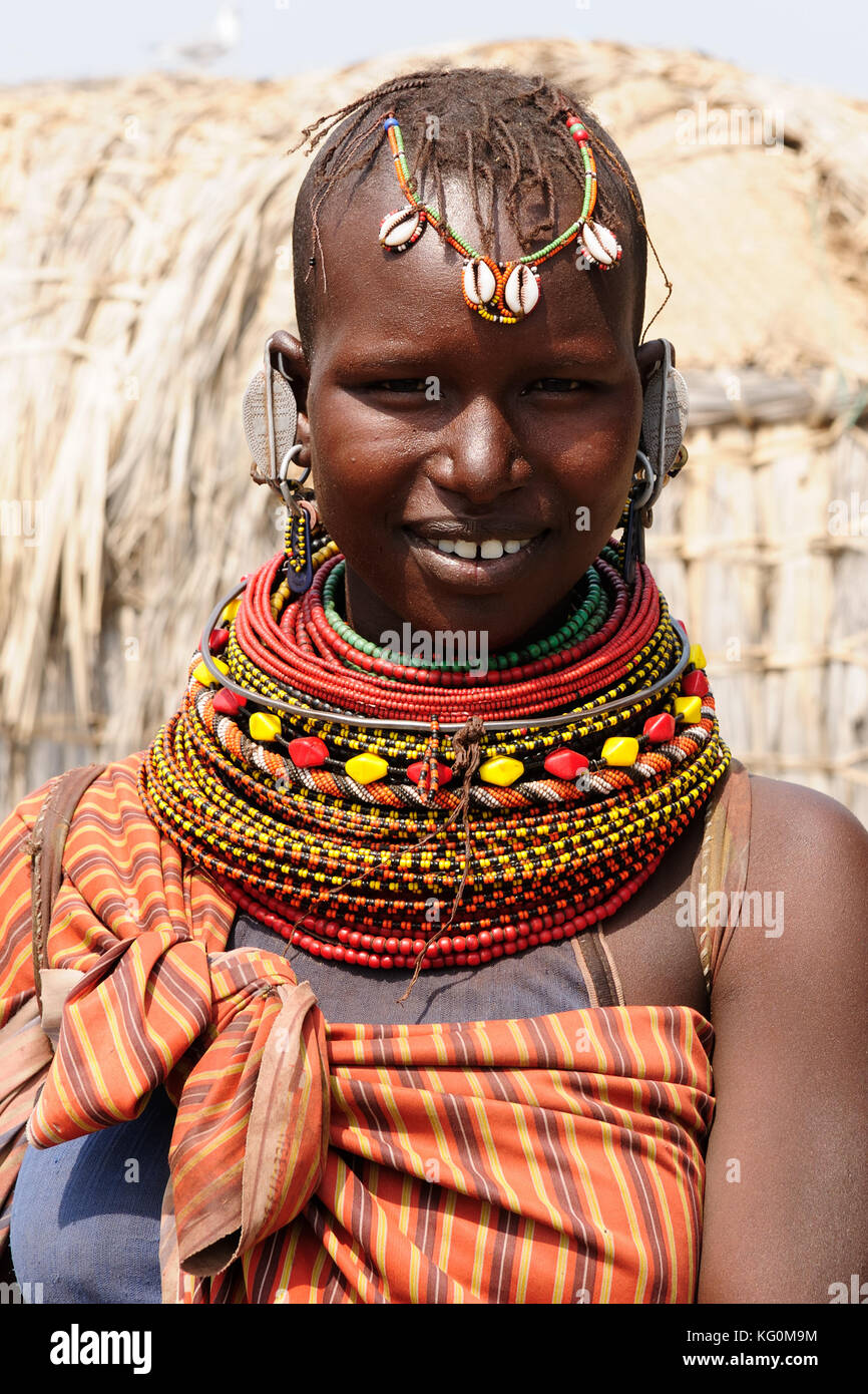 KOMOTE, KENYA - JULY 12: African woman from the El Molo tribe in the traditional dress in transit to the market in Kenya, Komote in July 12, 2013 Stock Photo