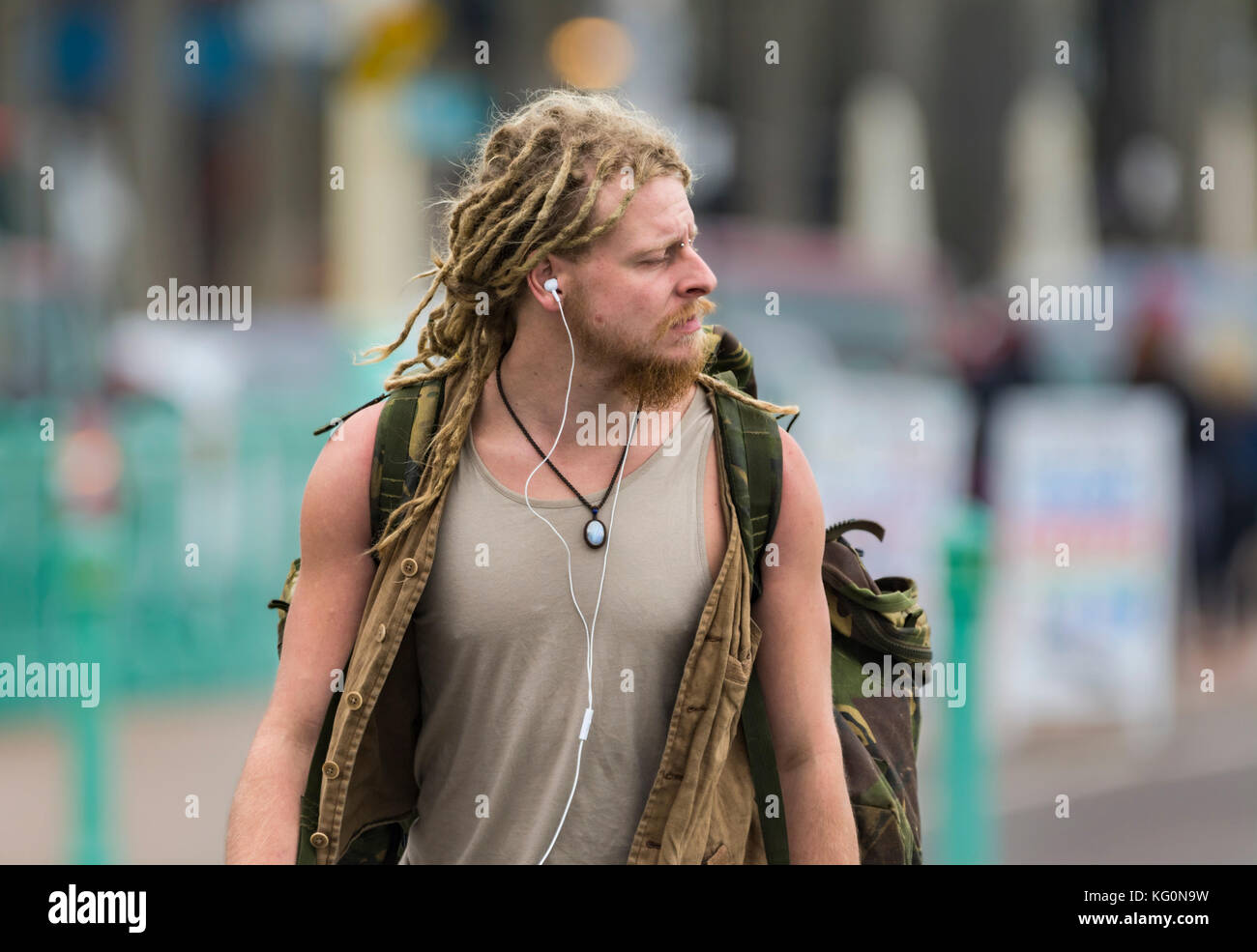 Young man with dreadlocks walking in the UK. Stock Photo