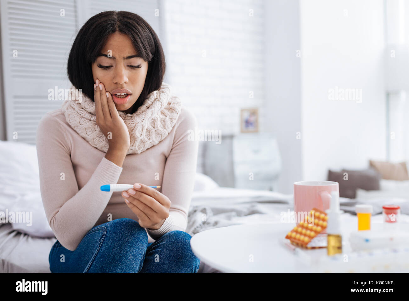 Surprisingly High Temperature Of A Young Pleasant Woman Stock Photo - Alamy