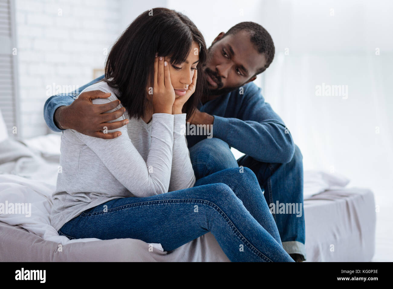 Kind attentive man supporting his sad girlfriend Stock Photo