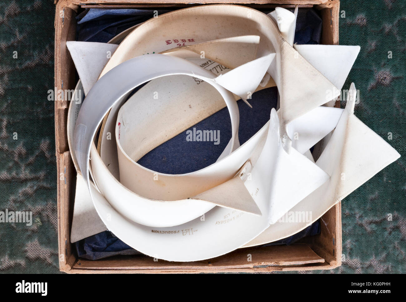 UK. A cardboard box full of old shirt collars for sale in a market Stock Photo