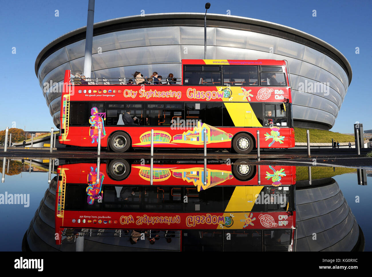 A City Sightseeing bus is reflected in a puddle outside the SSE Hydro ...