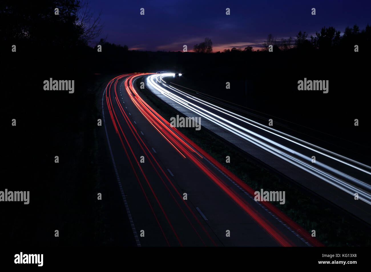 Car light trails at night on motorway in sunset Stock Photo - Alamy