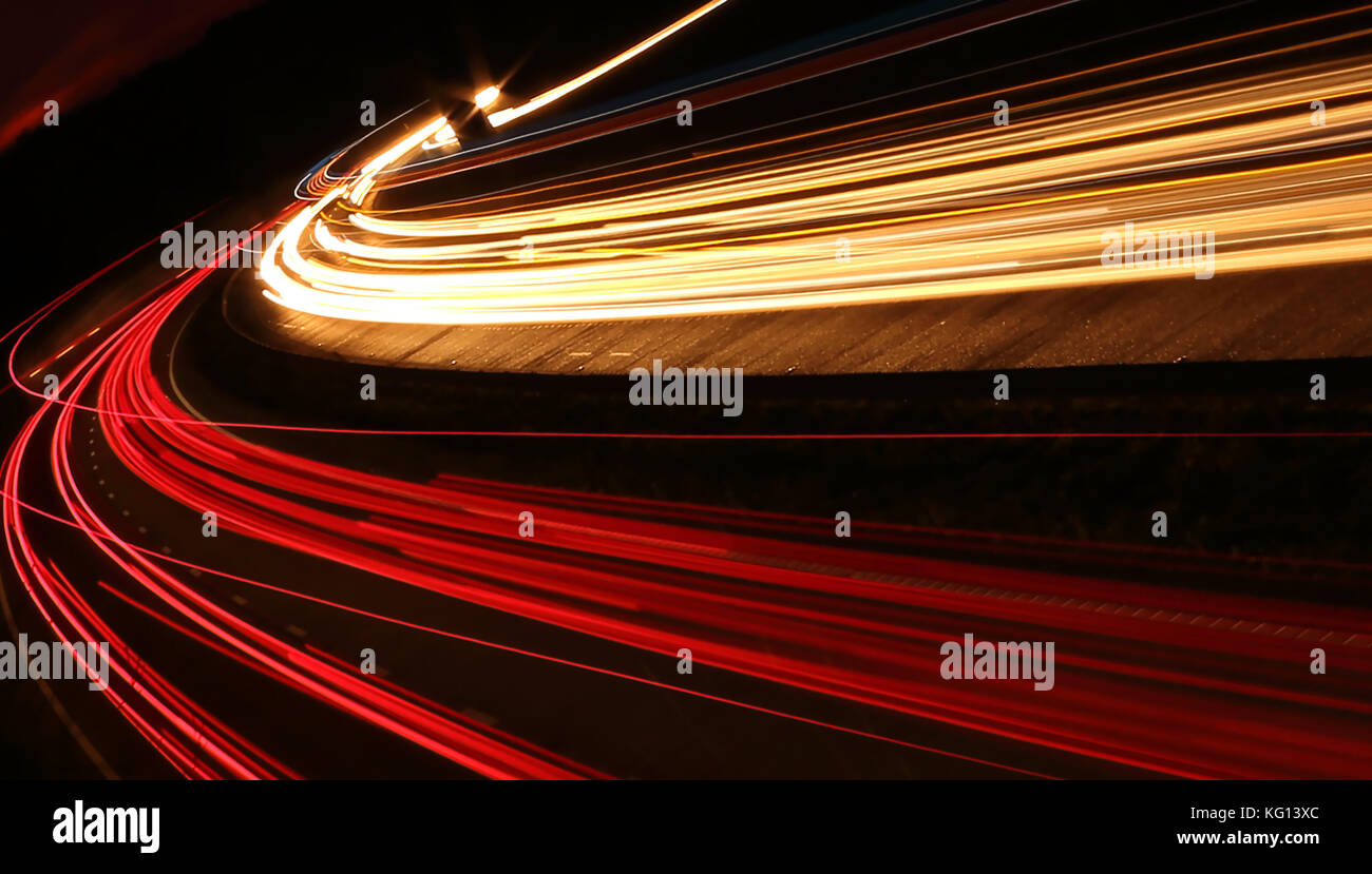 Car light trails at night on motorway in sunset Stock Photo Alamy