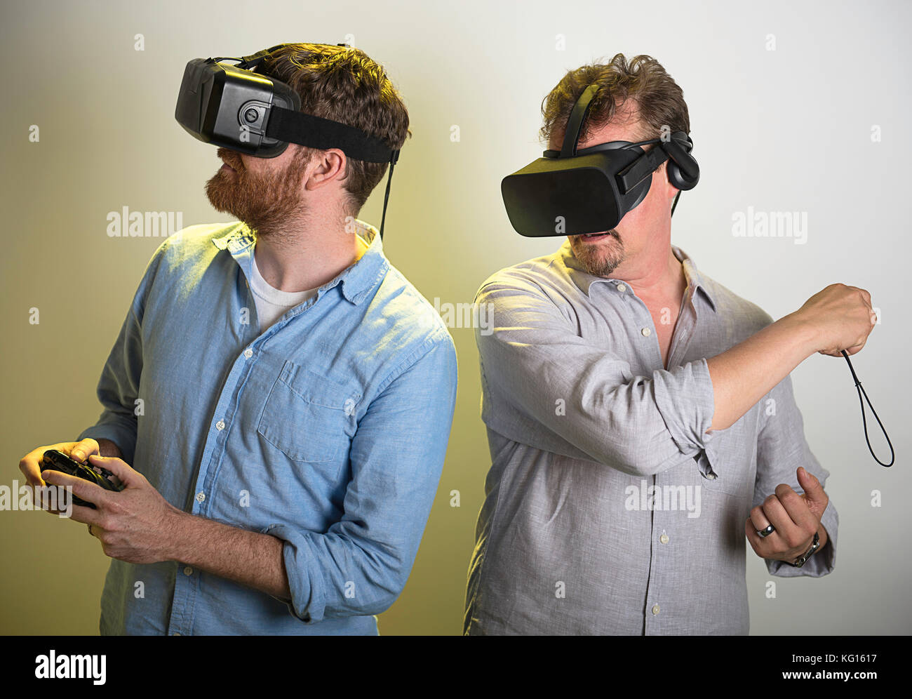 Two men playing with their VR headsets. Stock Photo