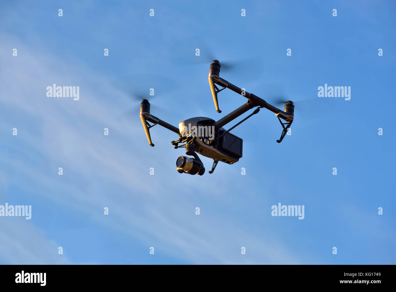 Flying big drone on blue sky background Stock Photo