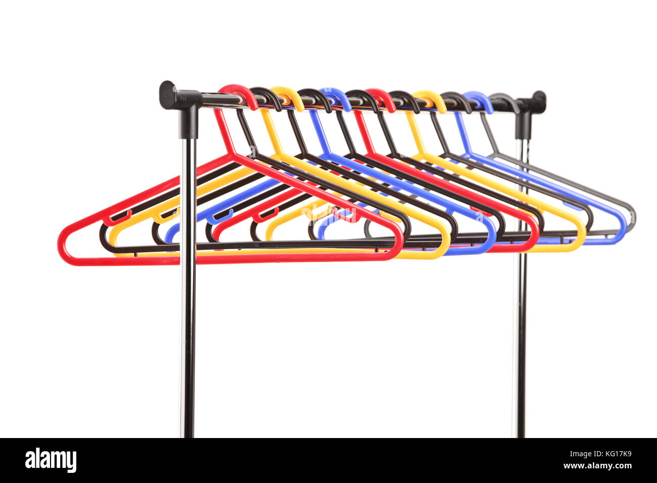 Plastic hangers on a rail isolated on white background Stock Photo