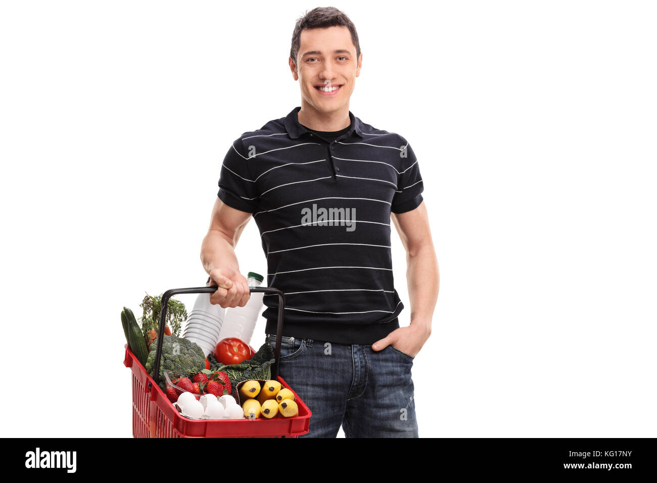 Young man with a shopping basket filled with groceries isolated on white background Stock Photo