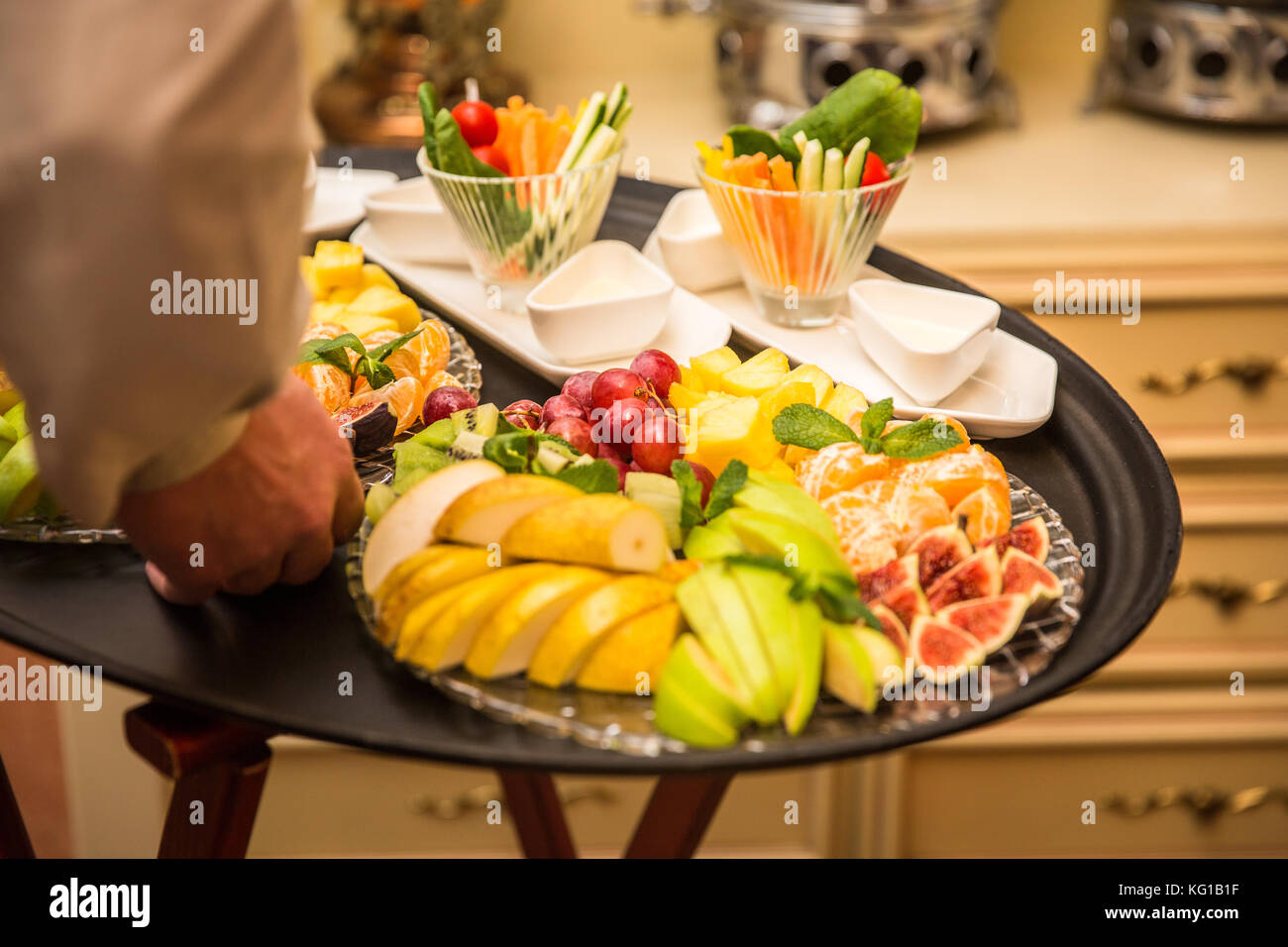 Waiter carrying tray hi-res stock photography and images - Alamy