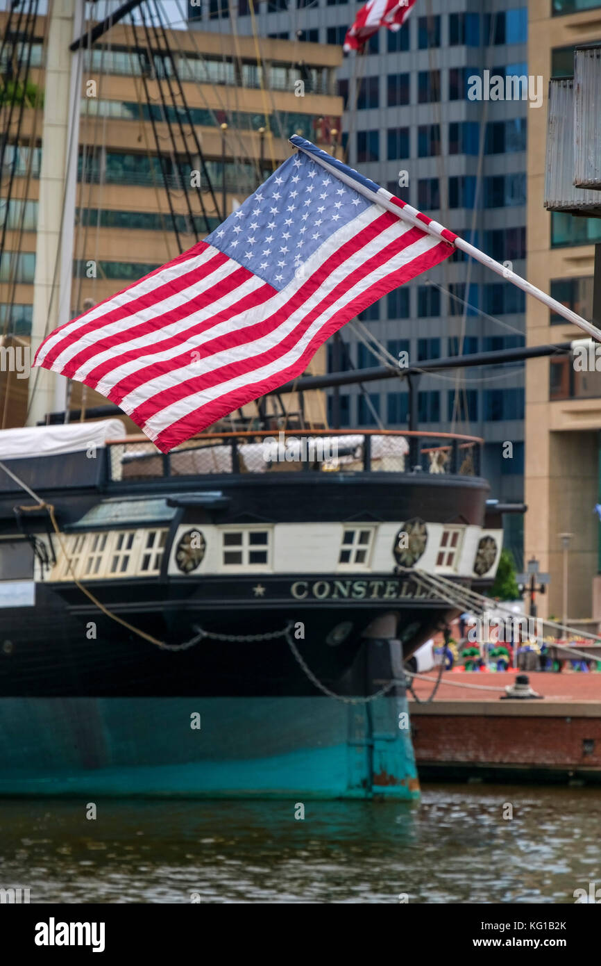 USS Constellation with the Stars and Stripes of the American Flag, Baltimore, Maryland, USA Stock Photo