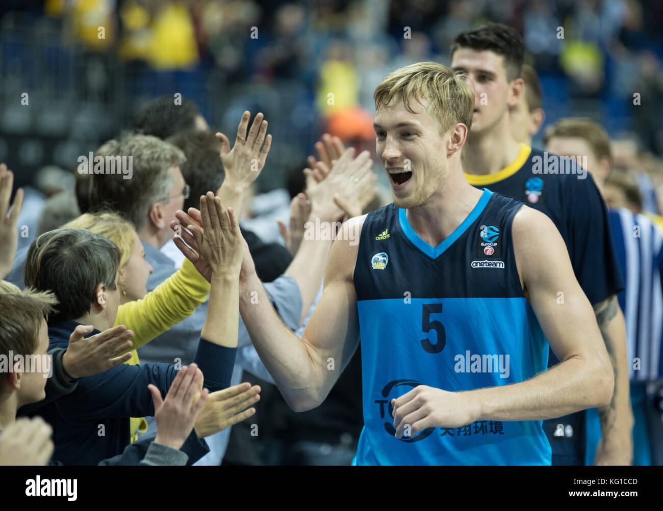 Alba's Niels Giffey and his team celebrating victory and highfiving the fans after the Eurocup