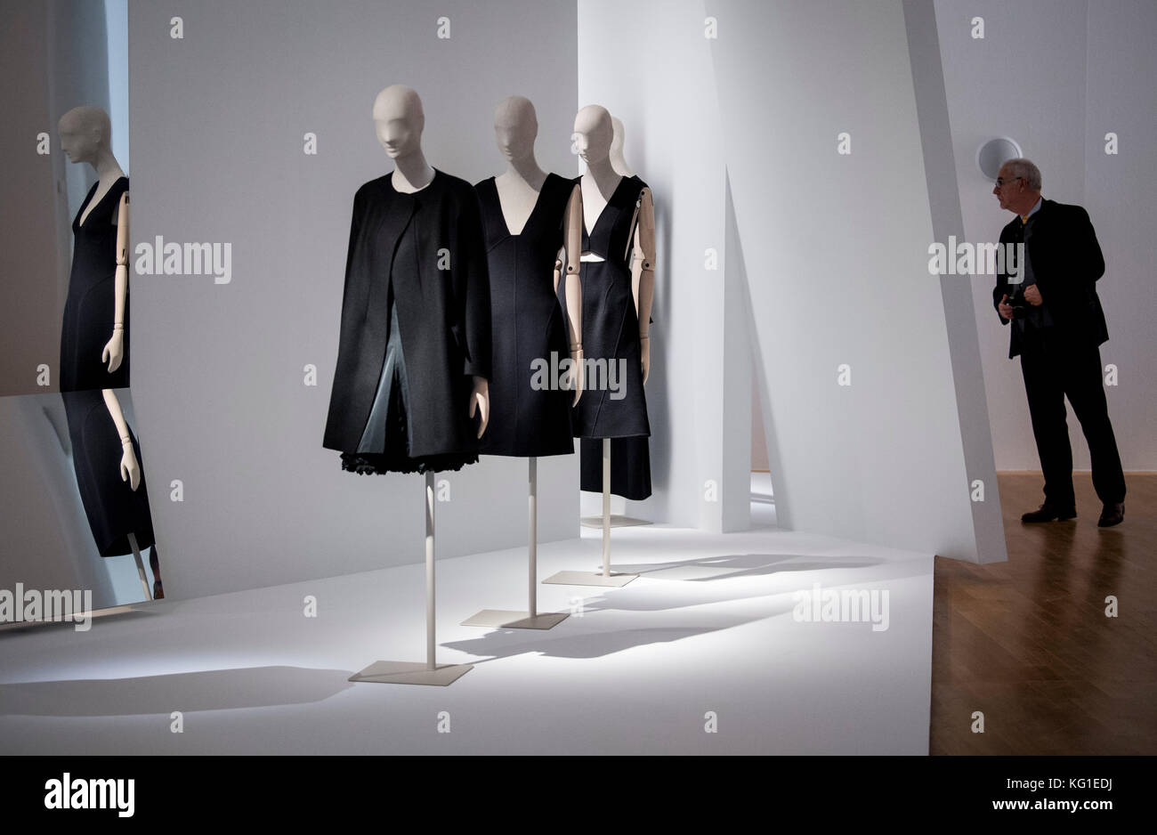 A man standing in front of the exhibits in the exhibition "Jil Stock Photo  - Alamy