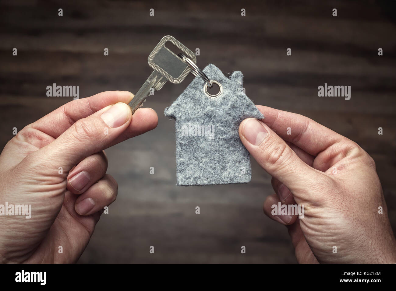 Latchkey in between two hands Stock Photo Alamy