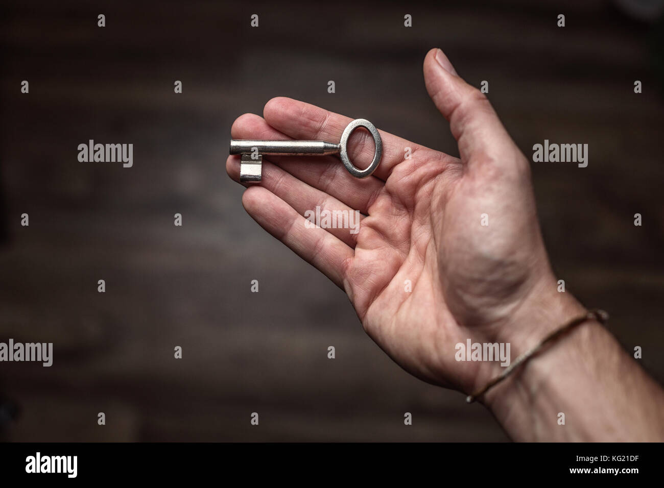 Simple key held in the palm of the hand Stock Photo Alamy