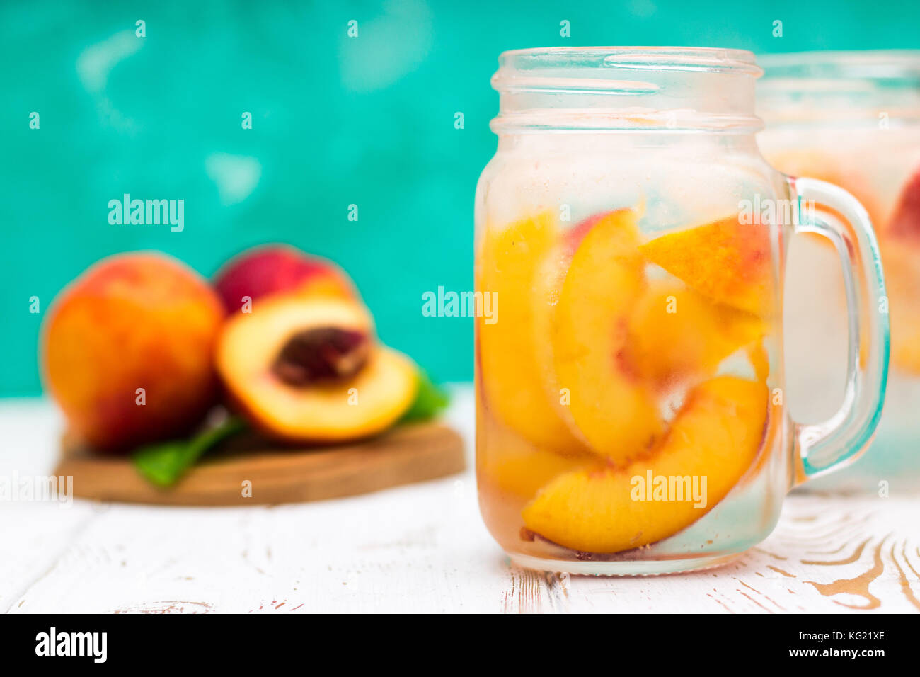 Homemade iced lemonade with ripe peaches. Fresh peach ice tea in a