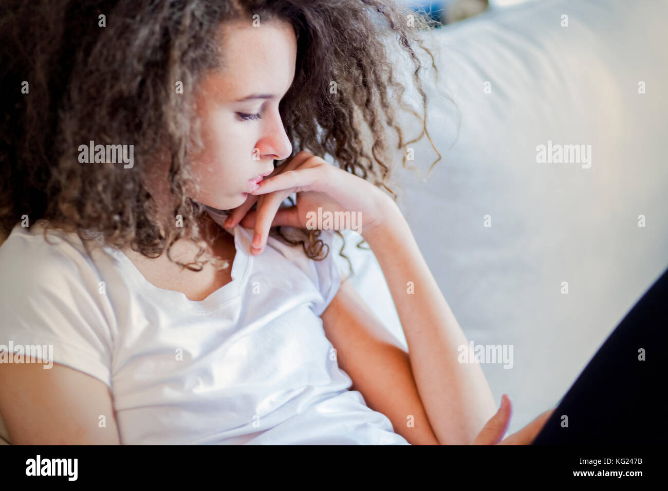 Teen sitting on couch hi-res stock photography and images - Alamy