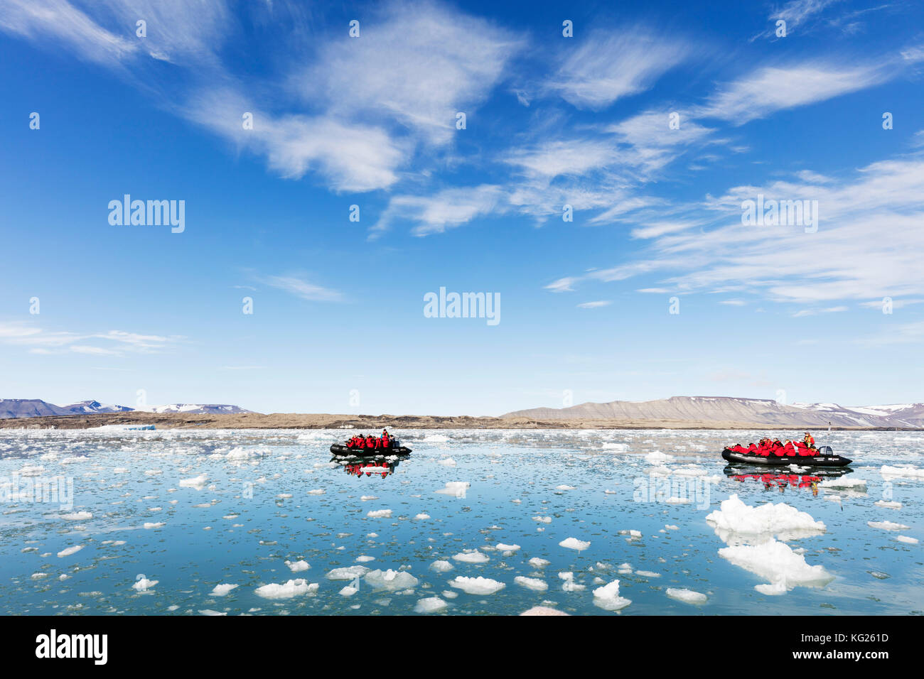 Tourist zodiac in an iceberg filled glacial lagoon, Spitsbergen, Svalbard, Arctic, Norway, Europe Stock Photo