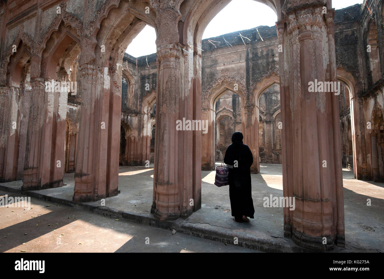 Muslim woman entering the semi-derelict 18th century Imambara and Mosque, Lucknow Residency, Uttar Pradesh, India, Asia Stock Photo