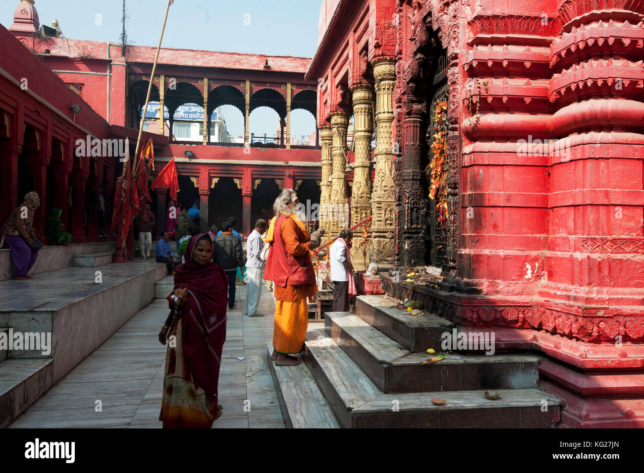 Hindu pilgrim dressed in saffron and red, visiting the Durga Mandir, one of the most famous temples in Varanasi, Uttar Pradesh, India, Asia Stock Photo