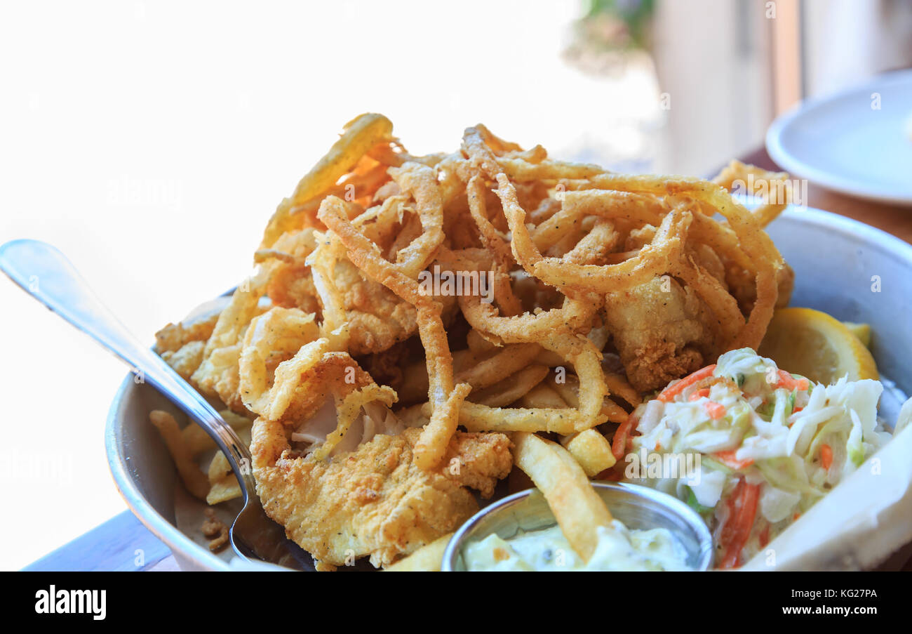 Fried Fish and Chips with Onion Strings and Coleslaw Stock Photo - Alamy