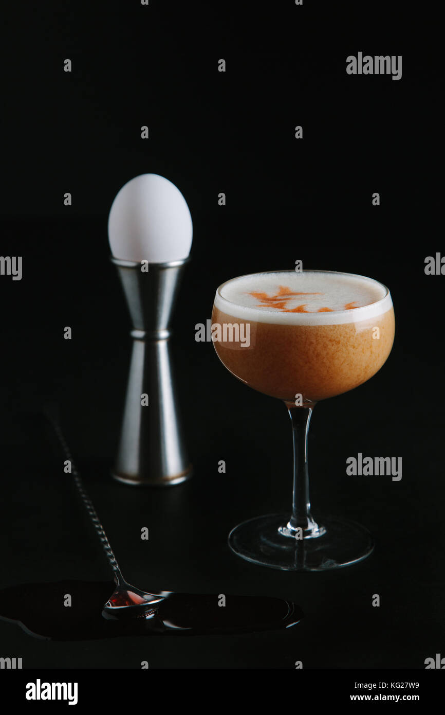 Brown liquor cocktail with egg foam on dark background Stock Photo Alamy