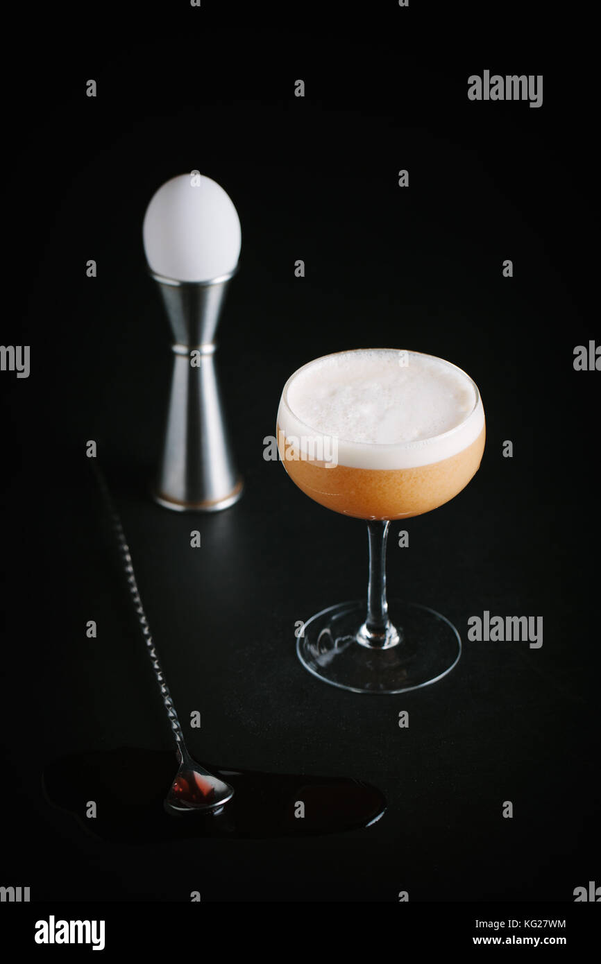 Brown liquor cocktail with egg foam on dark background Stock Photo Alamy