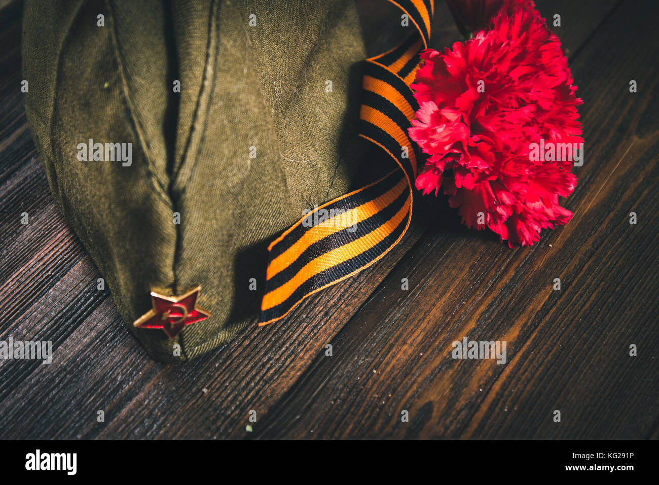 Carnation flowers, George Ribbon and military garrison cap with a red ...