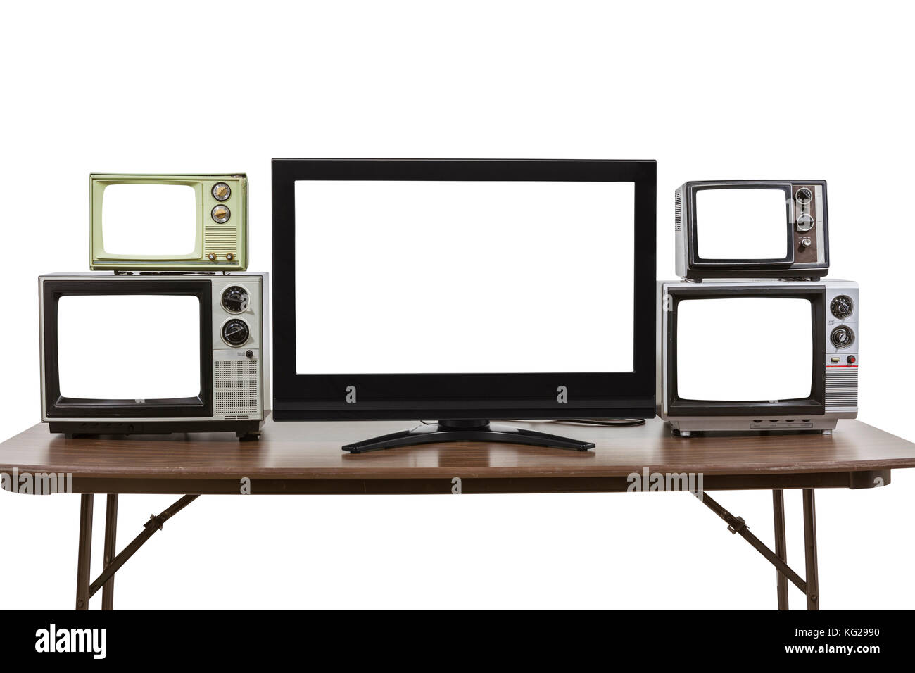 Modern and vintage televisions on table isolated on white with cut out screens. Stock Photo