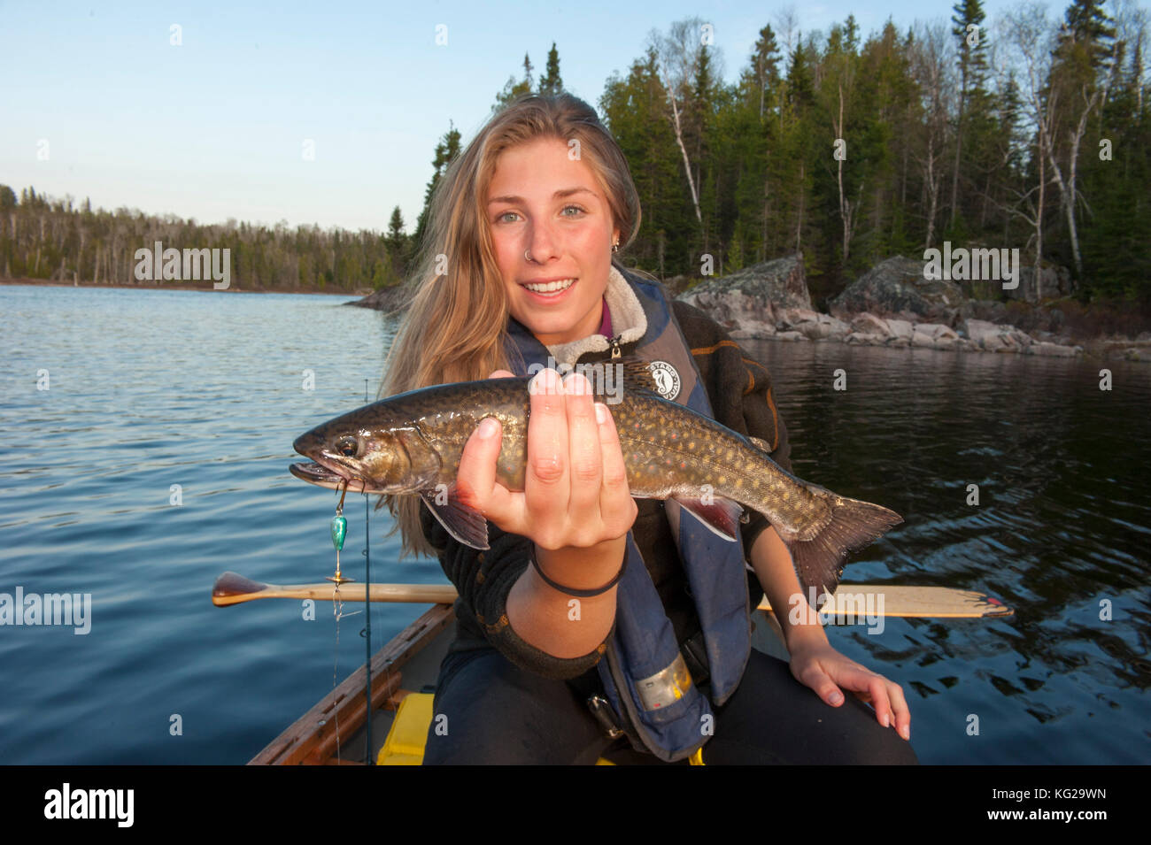 Young lady with small Lake trout Stock Photo Alamy