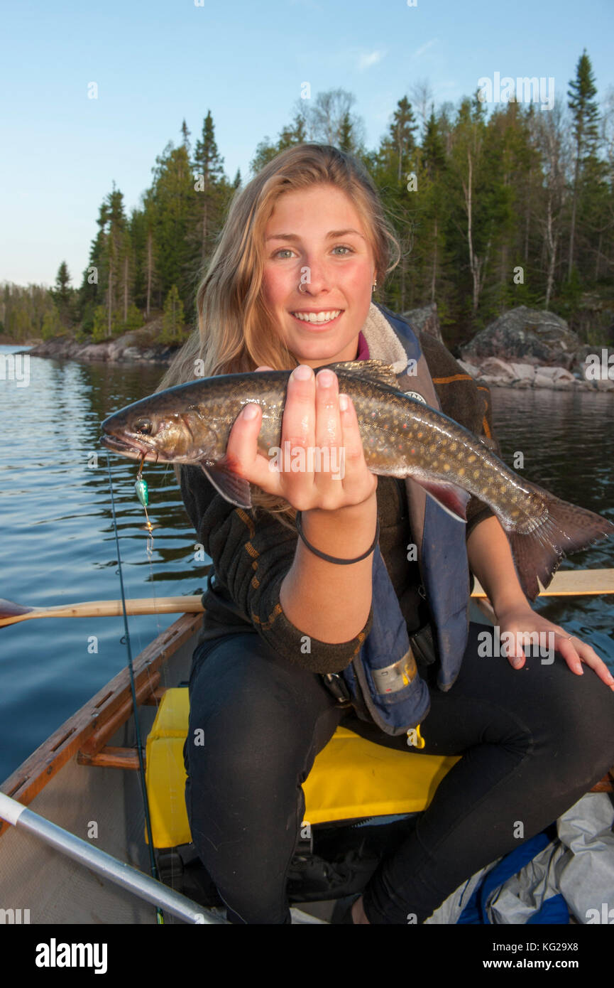 Young lady with small Lake trout Stock Photo Alamy