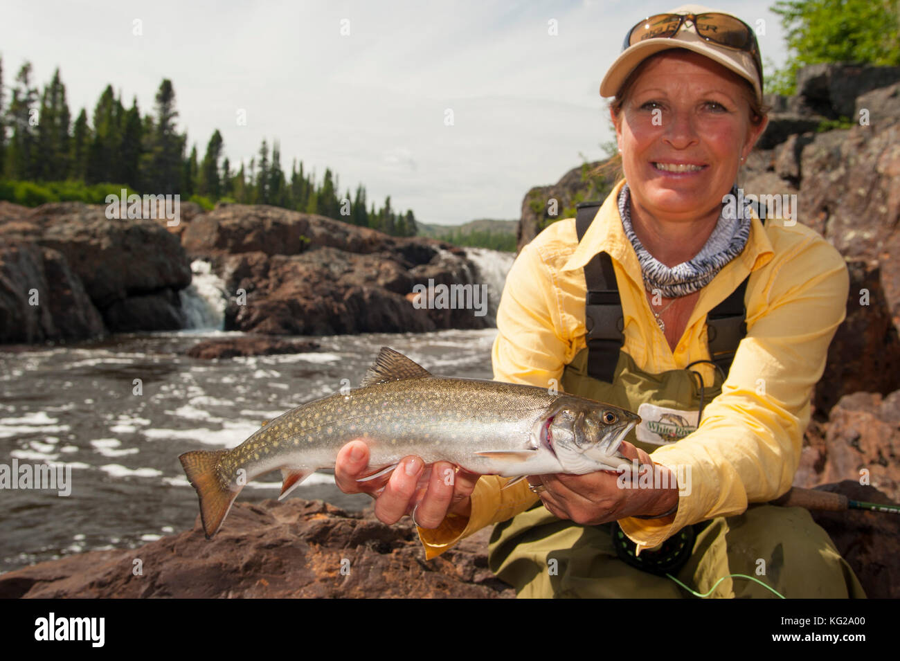 Beautiful woman fly fishing for brook trout Stock Photo - Alamy