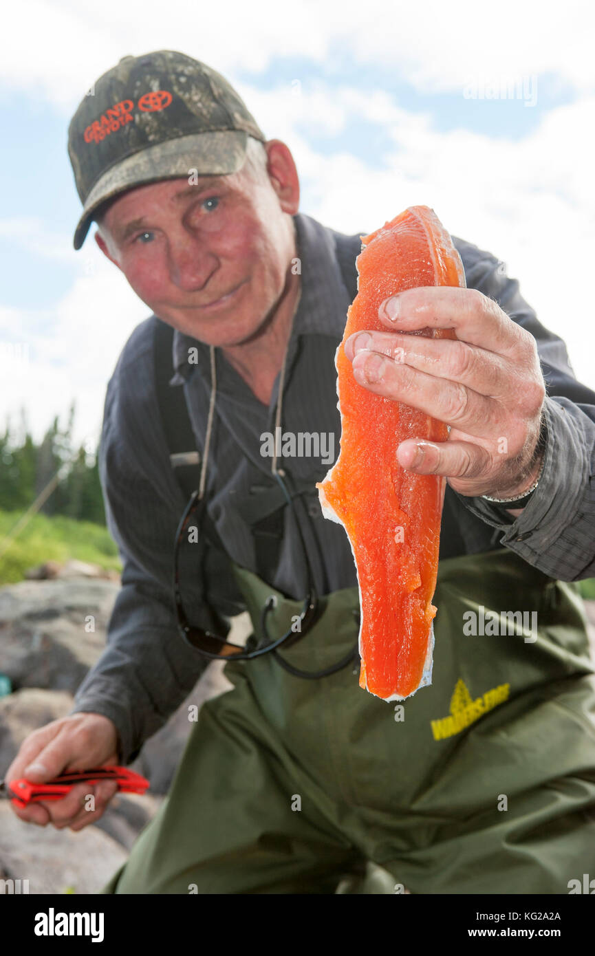 Labrador fishing guide with brook trout filet Stock Photo Alamy