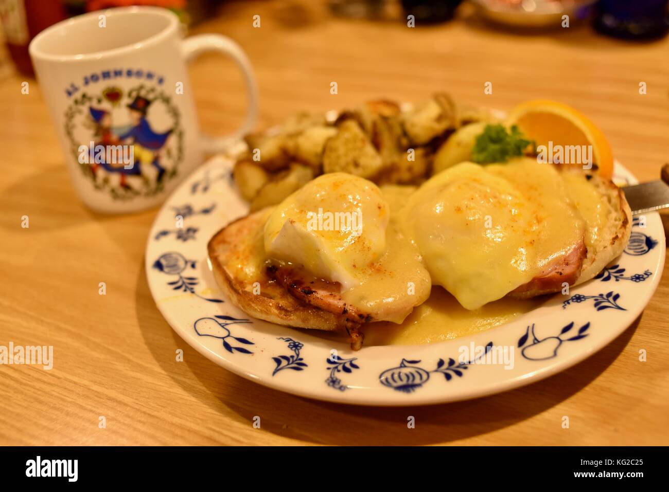 Eggs Benedick with potatoes and fruit for breakfast at Al Johnson's Swedish Restaurant in the Door County community of Sister Bay, Wisconsin, USA. Stock Photo