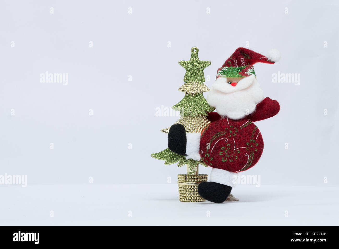 Adorable red Santa Claus with gold and green christmas tree in white ...
