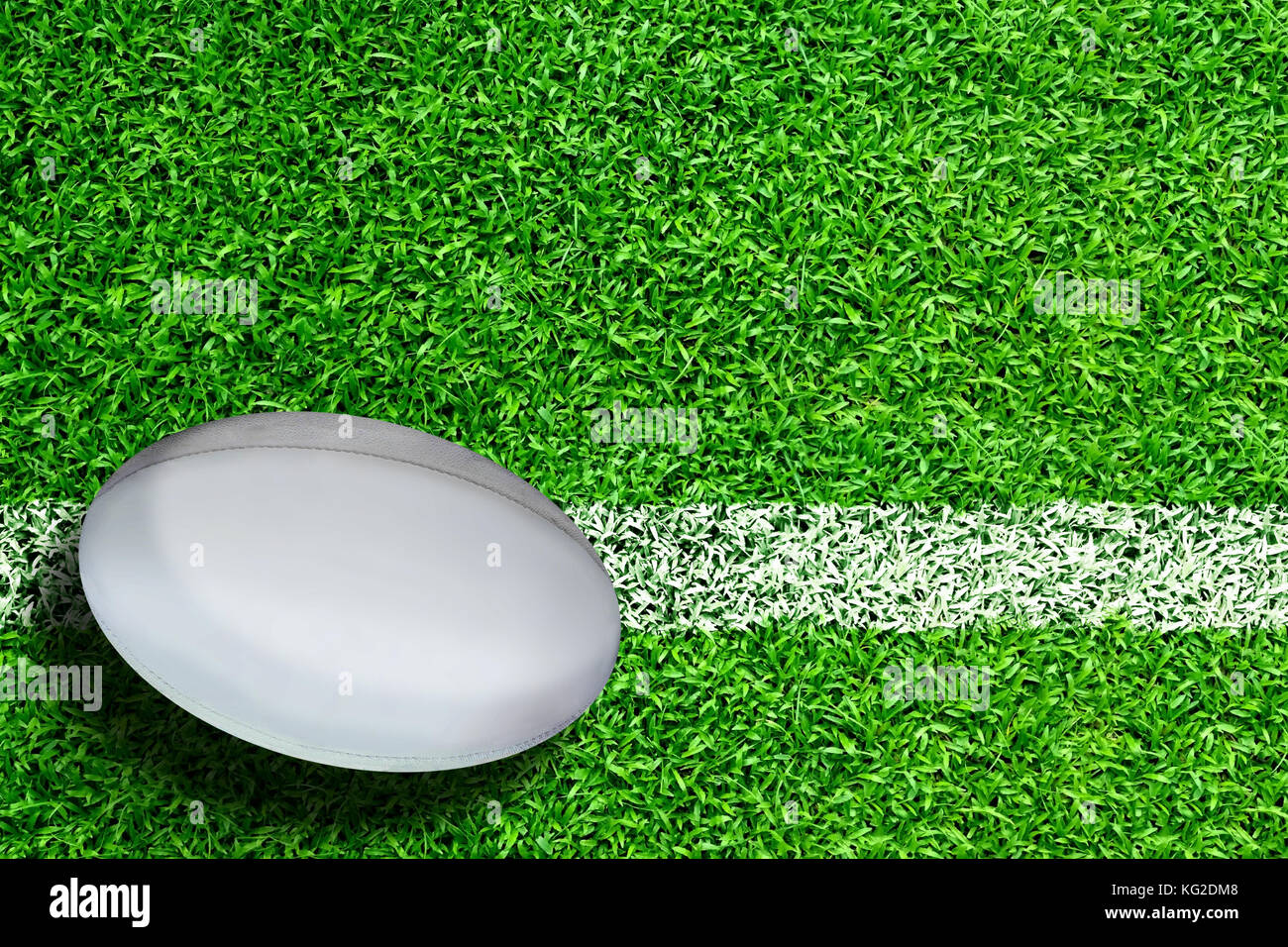 Rugby ball on field with white line marking and copy space. Line ...