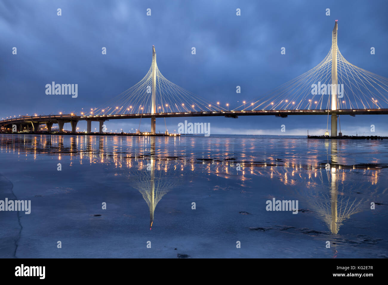 Western high-speed diameter in Saint-Petersburg. The new cable-stayed bridge across the Neva river is reflected in the ice. Stock Photo